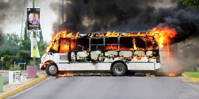 A burning bus, set alight by cartel gunmen to block a road, is pictured during clashes with federal forces following the detention of Ovidio Guzman, son of drug kingpin Joaquin "El Chapo" Guzman, in Culiacan, Sinaloa state, Mexico Oct. 17, 2019. (REUTERS/Jesus Bustamante)