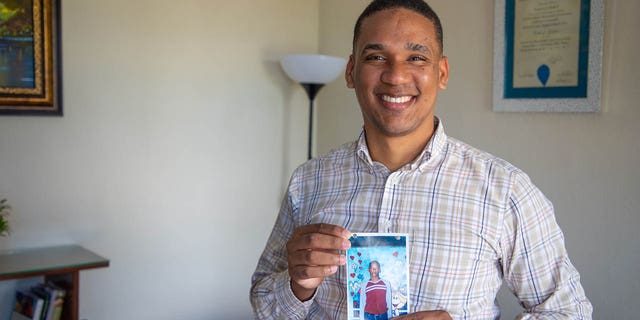 Jose Frank holds one of his sponsorship photos from childhood.