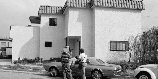 Newsmen examine the car of Dorothy Stratten, Playmate of the year 1980, after the nude bodies of her and her husband, Paul Snider, were found dead in this apartment in Los Angeles Aug. 14, 1980. Police said she was killed with a shotgun blast in the face, and Snider's body was on the floor on top of the gun.