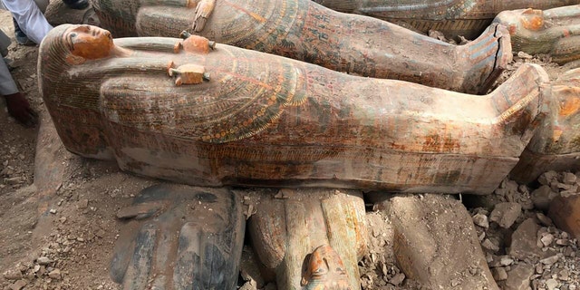 This photo provided by the Egyptian Ministry of Antiquities shows recently discovered coffins with inscriptions and paintings, in the southern city of Luxor.