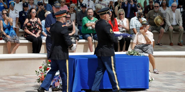 An honor guard carries the remains of during U.S. Army veteran Edward K. Pearson and an American flag during an open funeral service Tuesday, Oct. 1, 2019, at the Sarasota National Cemetary in Sarasota, Fla.