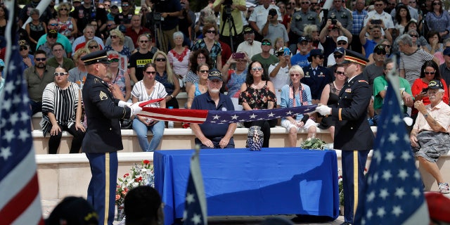 An honor guard folds an American flag during an open funeral service for U.S. Army veteran Edward K. Pearson Tuesday, Oct. 1, 2019, at the Sarasota National Cemetary in Sarasota, Fla.