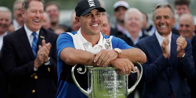 FILE - In this May 19, 2019, file photo, Brooks Koepka poses with the Wanamaker Trophy after winning the PGA Championship golf tournament, in Farmingdale, N.Y. Koepka begins a new season this week in Las Vegas. (AP Photo/Julio Cortez, File)