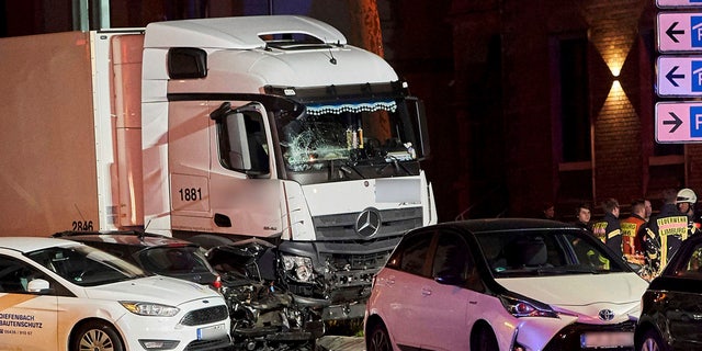 In this Monday, Oct. 7, 2019 photo s truck stands between damaged cars in Limburg, Germany.