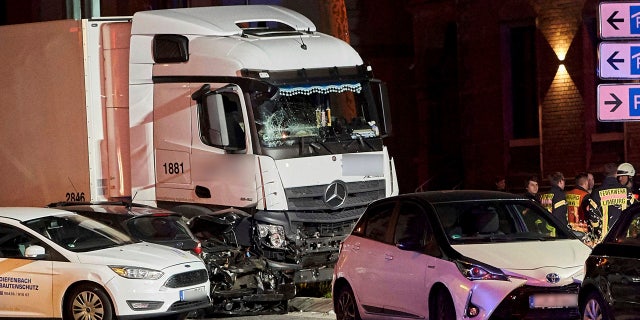 In this Monday, Oct. 7, 2019 photo s truck stands between damaged cars in Limburg, Germany.