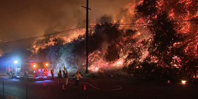 Mandatory evacuations were issued after a fire erupted on a hillside near the Getty Center museum in Los Angeles.