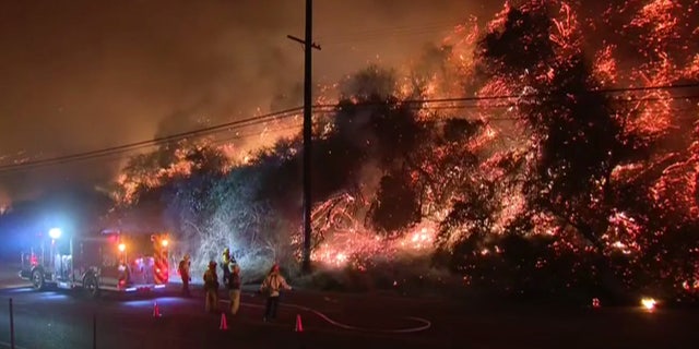 Mandatory evacuations were issued after a fire erupted on a hillside near the Getty Center museum in Los Angeles.