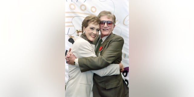 US director Blake Edwards poses with his wife Julie Andrews, after receiving the Legion of Honor, on May 09, 1992 during the International Cannes Film Festival.