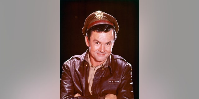 Bob Crane (1928-1978), US actor, in costume in a studio portrait, against a black background, issued for the US television series, 'Hogan's Heroes', USA, circa 1968. The PoW sitcom starred Crane as 'Colonel Robert E. Hogan.'