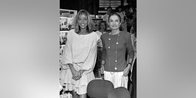 Good friends Carly Simon and Jackie Onassis pose for a picture at Bunch of Grapes Bookstore on Martha's Vineyard, Massachusetts, 9/2/89.