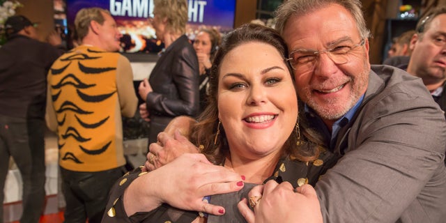 Chrissy Metz, left, and comedian Bill Engvall hug it out on the set of "Hollywood Game Night." (Photo by: Ron Batzdorff/NBCU Photo Bank/NBCUniversal via Getty Images)