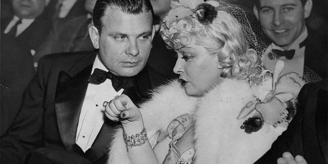 Actress Mae West and Boris Petroff with others attending the Tournament of Champions at Madison Square Garden.