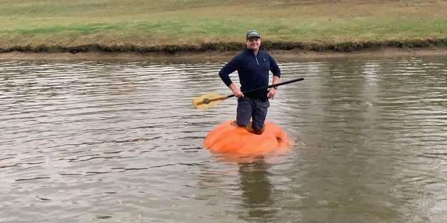 Justin Ownby shows off his homemade pumpkin kayak. (Courtesy of Christin Ownby)