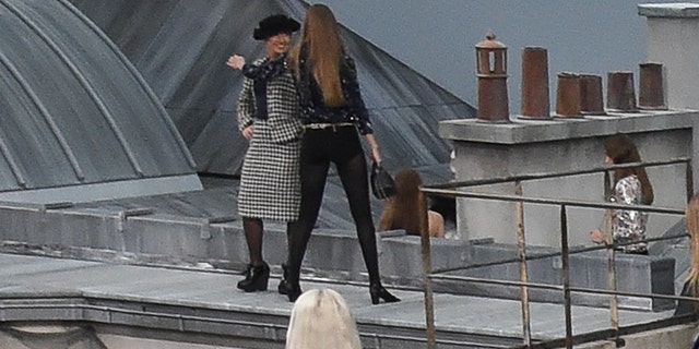 French comedian Marie Benoliel aka 'Marie S’Infiltre' gets kicked out by Gigi Hadid during the Chanel Womenswear Spring/Summer 2020 show as part of Paris Fashion Week on October 01, 2019 in Paris, France. (Photo by Stephane Cardinale - Corbis/Corbis via Getty Images)