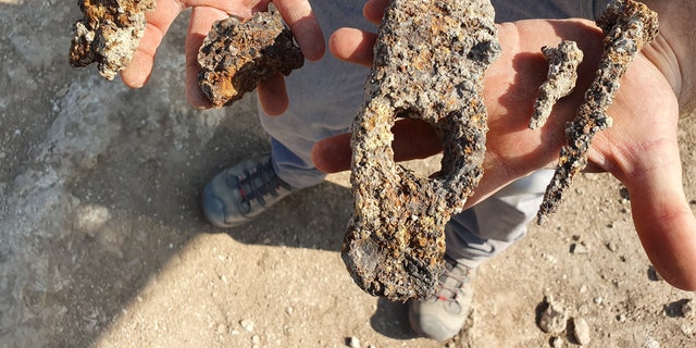 The ancient iron hammer and nails that were found during the Usha excavation.