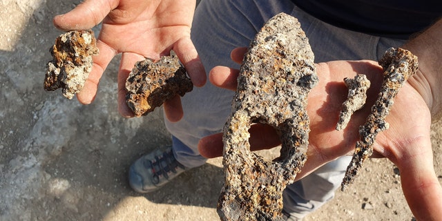 The ancient iron hammer and nails that were found during the Usha excavation.