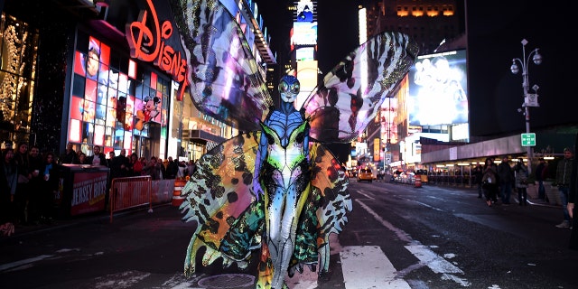 Heidi Klum gives Times Square visitors a sneak peek of her Halloween costume before hosting her annual party at TAO Downtown sponsored Bby Moto X on October 31, 2014 in New York City. (Photo by Dimitrios Kambouris/Getty Images for Heidi Klum)