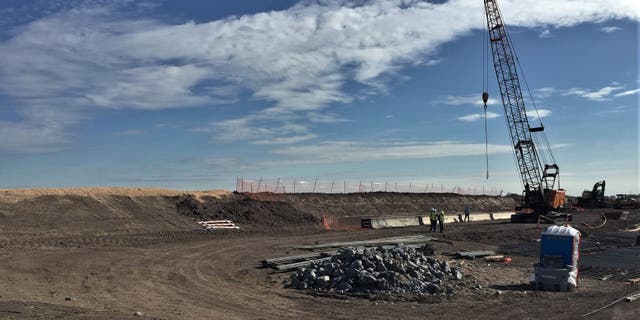 Workers lay the foundation for new wall near the Rio Grande Valley river, an area with many crossings, just southeast of McAllen, Texas. (Courtesy of CBP)