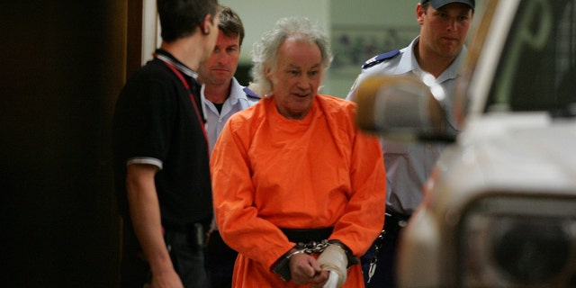 January 26, 2009. Goulburn, NSW - (EUROPE AND AUSTRALASIA OUT) Dressed in his orange overalls and handcuffed and with his left hand bandaged after cutting off his own finger and attempting to post it to the High Court. Ivan Milat was escorted out of Goulburn Hospital last night, and taken back to prison. (Photo by Gary Ramage / Newspix / Getty Images)