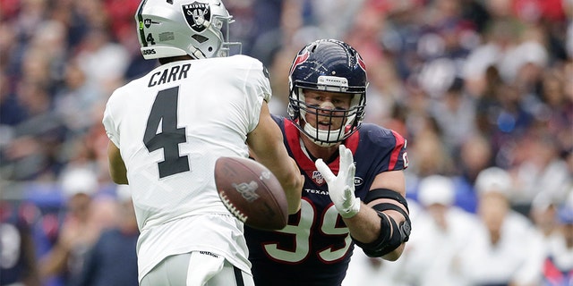 Houston Texans defensive end J.J. Watt (99) blocks a pass by Oakland Raiders quarterback Derek Carr (4) during the first half of an NFL football game Sunday, Oct. 27, 2019, in Houston. (AP Photo/Michael Wyke)