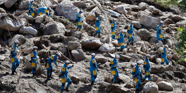 Rescuers search for missing persons at the site of a landslide triggered by Typhoon Hagibis, in Marumori town, Miyagi prefecture, Japan Wednesday, Oct. 16, 2019.