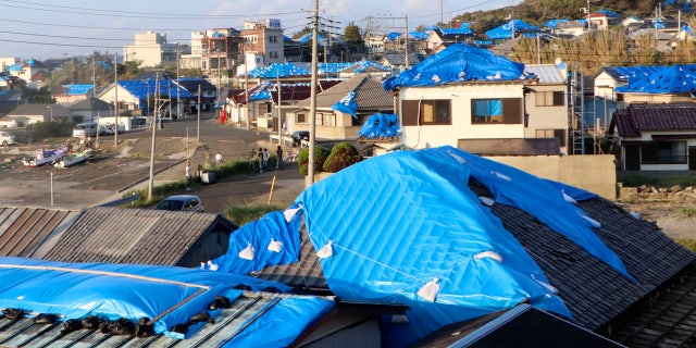 This Oct. 8, 2019, photo shows the sheet-covered roofs of the houses damaged by typhoon Faxai in Tateyama, near Tokyo.
