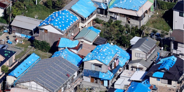 This Oct. 9, 2019, photo shows the sheet-covered roofs of the houses damaged by typhoon Faxai in Kyonan, near Tokyo. Japan's weather agency is warning a powerful typhoon may bring torrential rains to central Japan over the weekend.