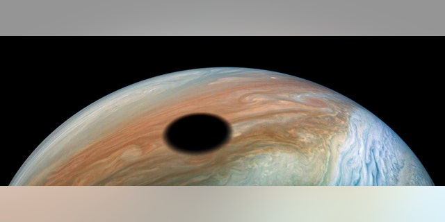 The giant black spot on the surface of Jupiter.
