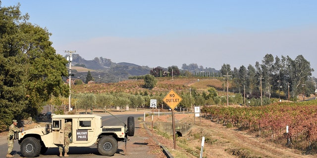 Soldiers from the 49th Military Police Brigade operate a traffic control point along Highway 101 in Healdsburg, assisting local law enforcement with evacuated areas threatened by the Kincade fire. (California National Guard)