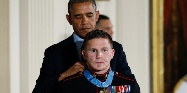 FILE - Retired Marine Cpl. William "Kyle" Carpenter receives the Medal of Honor from U.S. President Barack Obama during a Medal of Honor ceremony in the East Room of the White House on June 19, 2014 in Washington, DC. Carpenter received the medal for taking the blast from a grenade to protect fellow Marines and sustained major wounds. Carpenter is the eighth living recipient chosen for the high honor.  