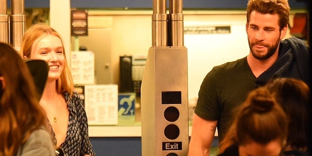 Newly single Liam Hemsworth is seen with an ear to ear smile in the underground subway with actress Maddison Brown in Soho, New York. 