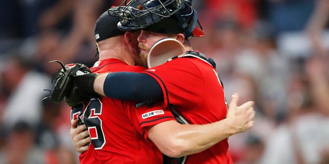 Atlanta Braves catcher Brian McCann, left, embraces Atlanta Braves catcher Brian McCann after Game 2 of a best-of-five National League Division Series St. Louis Cardinals, Friday, Oct. 4, 2019, in Atlanta. The Atlanta Braves won 3-0. (AP Photo/John Bazemore)
