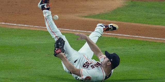 Houston Astros starting pitcher Justin Verlander tries to make a play on a ball hit by Washington Nationals' Ryan Zimmerman during the fourth inning of Game 2 of the baseball World Series Wednesday, Oct. 23, 2019, in Houston. (AP Photo/Eric Gay)