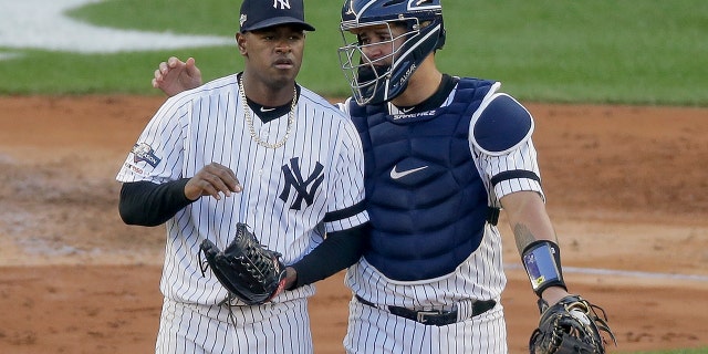 New York Yankees catcher Gary Sanchez talks on the mound with starting pitcher Luis Severino (40) during the fourth inning of Game 3 of baseball's American League Championship Series against the Houston Astros, Tuesday, Oct. 15, 2019, in New York. (AP Photo/Seth Wenig)