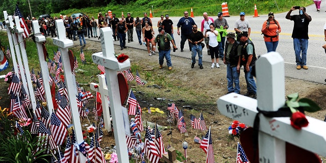 Motorcyclists visit a memorial for seven bikers killed in a June 2019 collision with a pickup truck in Randolph, N.H., July 6, 2019. (Associated Press)