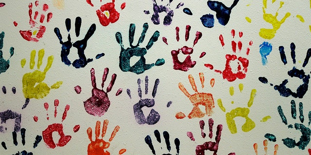 Handprints representing migrant children line a hall at a "tender-age" facility for babies, in Texas' Rio Grande Valley, Thursday, Aug. 29 in San Benito, Texas. Sheltering migrant children has become a booming business for Comprehensive Health Services, a Florida-based government contractor, as the number of children in government custody has swollen to record levels over the past two years. (AP Photo/Eric Gay)