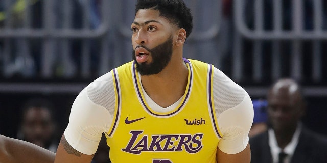 Los Angeles Lakers forward Anthony Davis dribbles during the first half of the team's preseason NBA basketball game against the Golden State Warriors in San Francisco, Saturday, Oct. 5, 2019. (AP Photo/Jeff Chiu)