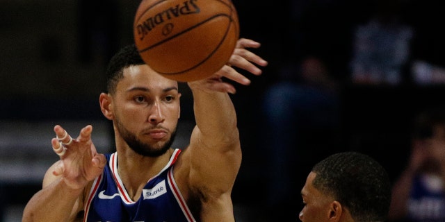 Philadelphia 76ers guard Ben Simmons, left, passes around Charlotte Hornets forward Miles Bridges in the second half of a preseason NBA basketball game in Winston-Salem, N.C., Friday, Oct. 11, 2019. (AP Photo/Nell Redmond)