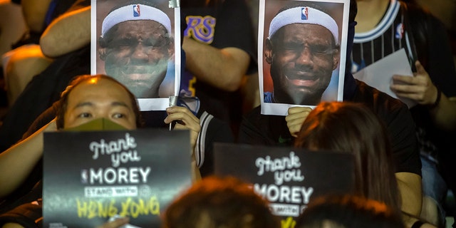 Demonstrators reason adult photos of LeBron James grimacing during a convene during a Southorn Playground in Hong Kong, Tuesday, Oct. 15, 2019. (AP Photo/Mark Schiefelbein)