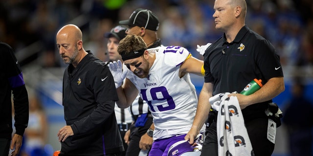 Minnesota Vikings wide receiver Adam Thielen (19) reacts after putting weight on his right leg, as he walks off the field with a hamstring injury in the first quarter of an NFL football game against the Detroit Lions, Sunday, Oct. 20, 2019, in Detroit. (Jerry Holt/Star Tribune via AP)