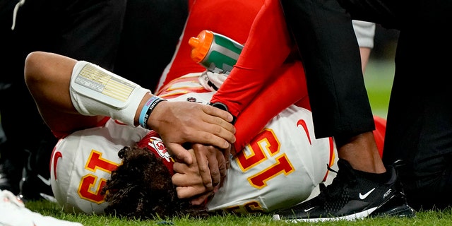 Kansas City Chiefs quarterback Patrick Mahomes (15) is helped by trainers after getting injured against the Denver Broncos during the first half of an NFL football game, Thursday, Oct. 17, 2019, in Denver. 