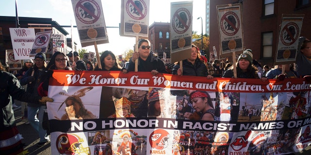 Protesters march from Peavey Park to US Bank Stadium to protest the use of