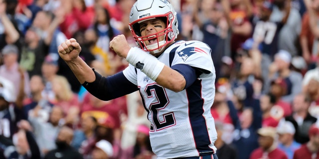 New England Patriots quarterback Tom Brady (12) reacts to a touchdown against the Washington Redskins during the second half of an NFL football game, Sunday, Oct. 6, 2019, in Washington. (AP Photo/Mark Tenally)