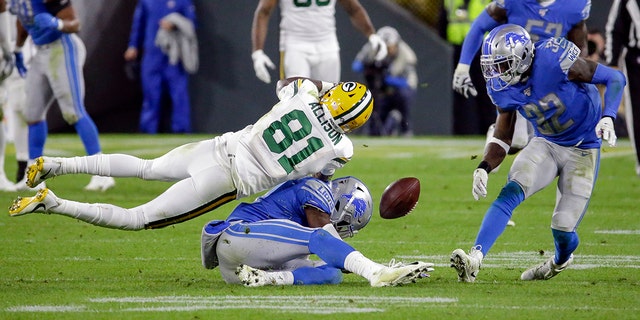 Detroit Lions defensive back Tracy Walker, bottom, and defensive back Tavon Wilson (32) break up a pass intended for Green Bay Packers wide receiver Geronimo Allison (81) during the second half of an NFL football game Monday, Oct. 14, 2019, in Green Bay, Wis. (AP Photo/Mike Roemer)