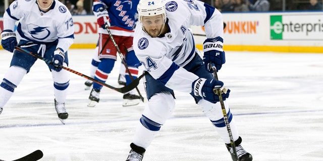 FILE - In this Feb. 2, 2019, file photo, Tampa Bay Lightning right wing Ryan Callahan (24) controls the puck during the first period of an NHL hockey game against the New York Rangers, at Madison Square Garden in New York. Callahan was interested in going into management after his NHL playing career ended because of degenerative disk disease in his back. Because he still has a year left on his contract, the 34-year-old couldn’t do that and decided to move into television instead with NHL Network. It’s a move that could create a road map for other injured players to stay in hockey. (AP Photo/Mary Altaffer, FIle)