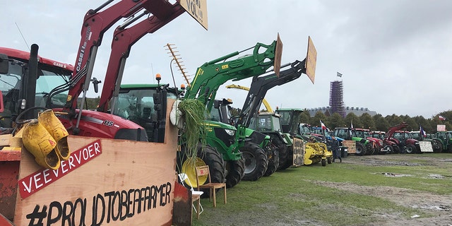 Dutch farmers line up tractors for a national day of protest to demand more respect for their profession. (AP Photo/Mike Corder)