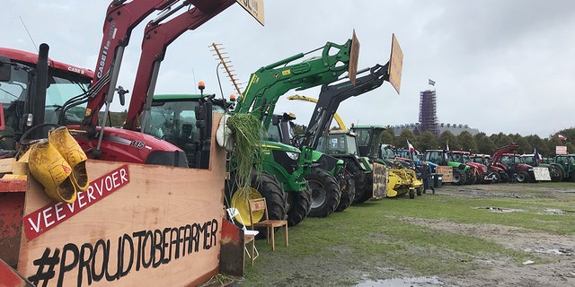 Dutch farmers line up tractors for a national day of protest to demand more respect for their profession. (AP Photo/Mike Corder)