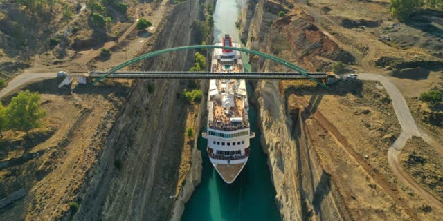 A 74-foot wide cruise ship impressively, safely passed through a historic Greek canal measuring 78-feet wide at its narrowest point last week, becoming the largest vessel to ever pass through the precarious passageway.