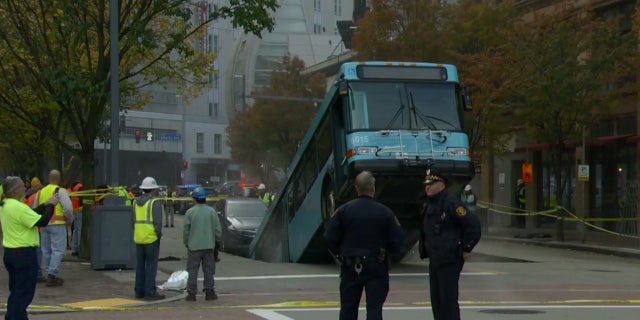 The rear of the bus fell into the sinkhole, leaving the front part sticking up in the air.