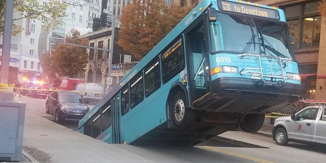 A bus was swallowed in a sinkhole in downtown Pittsburgh on Monday.